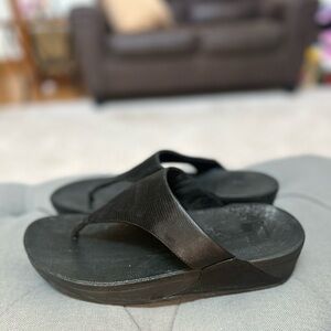 Black Lulu Fitflops. Like new just too wide for me.